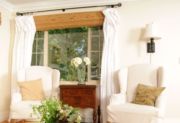 A luminous living room adorned with eco-chic woven wood shades.